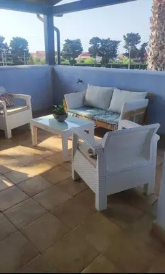 a patio with a couch and a coffee table at La terrazza vent8 in Buonfornello