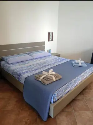 a bedroom with a bed with towels on it at La terrazza vent8 in Buonfornello