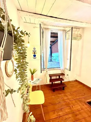 a room with a window and a table and a chair at Casa del Teatro in Palermo