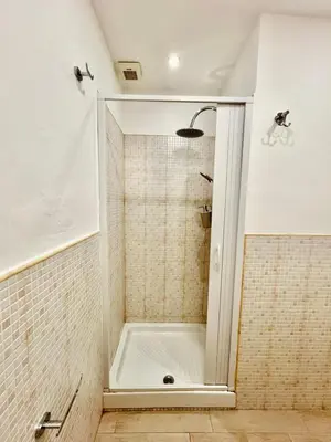 a bathroom with a shower with a white tub at Auri's home in Palermo