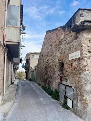an alley in an old stone building at Auri's home in Palermo