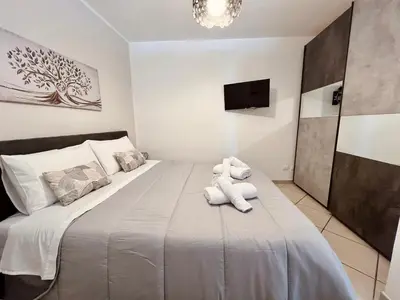 a bedroom with a large bed with towels on it at Auri's home in Palermo