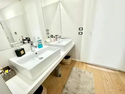 a white bathroom with two sinks and a mirror at Villa With Citrus Grove Near Caccamo in Termini Imerese