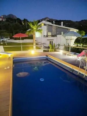 a swimming pool in front of a house at Villa With Citrus Grove Near Caccamo in Termini Imerese