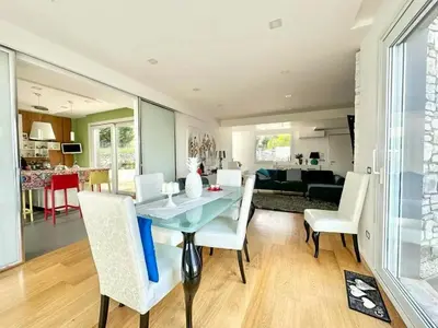 a dining room and living room with a table and chairs at Villa With Citrus Grove Near Caccamo in Termini Imerese