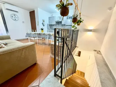 a living room with a couch and a stair case at Dal Moro in Palermo
