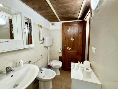 a bathroom with a white sink and a toilet at Casa del Cortile Secco in Palermo