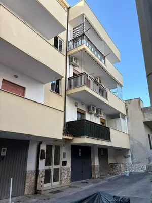an apartment building with balconies on the side of it at Delle Palme Holiday Home in Isola delle Femmine