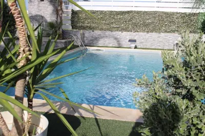 a swimming pool in a yard with plants at Villa del sole in Carini
