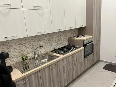 a kitchen with a sink and a stove at Come A To Casa in Aspra