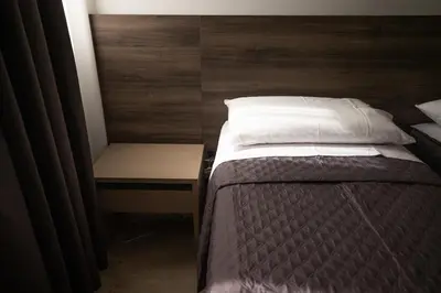 a bedroom with a bed and a nightstand next to it at Richgood Luxury homes - Villa Zefira sole in Altavilla Milicia