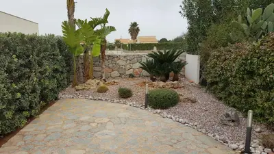 a garden with plants and a stone walkway at Villa La Chiocciola in San Vito lo Capo