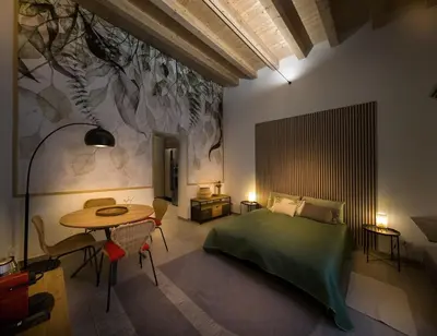a bedroom with a bed and a table with chairs at Bonsai Loft in Palermo