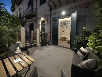 a courtyard with benches and a door to a building at Bonsai Loft in Palermo