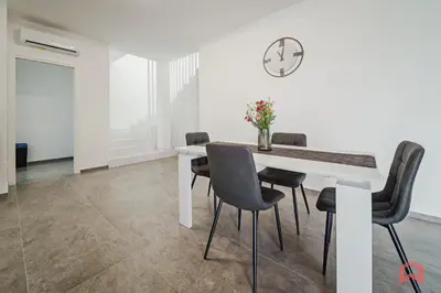 a dining room with a white table and chairs at Elegant Villa with Pool in Castellammare del Golfo