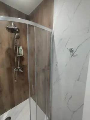 a bathroom with a shower with a glass door at Mumin in Carini