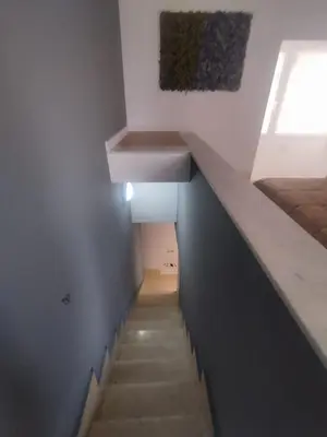 a staircase in a room with a bed and a sink at Mumin in Carini