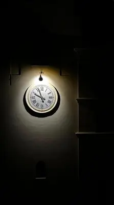 a clock on a wall in a dark room at Tra chiazza e casteddu in Mezzojuso