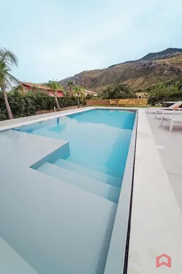a swimming pool with blue water in a villa at Deliziosa Villa con Piscina e Jacuzzi a Scopello in Castellammare del Golfo