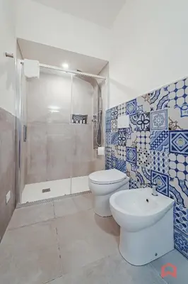 a bathroom with a toilet and a shower and a sink at Deliziosa Villa con Piscina e Jacuzzi a Scopello in Castellammare del Golfo