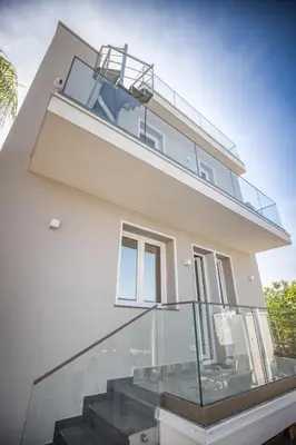 a house with a glass staircase in front of it at Richgood Luxury homes - Villa Zefira mare in Altavilla Milicia