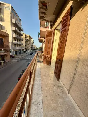 a balcony of a building on a city street at Casa Costa in Capaci