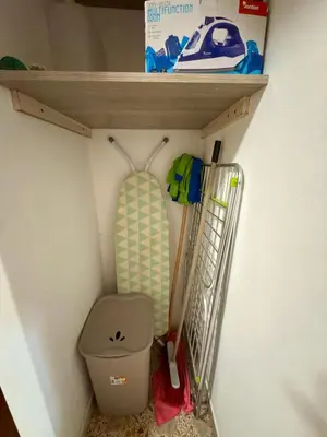 a shelf above a toilet with a surfboard on it at Casa Costa in Capaci