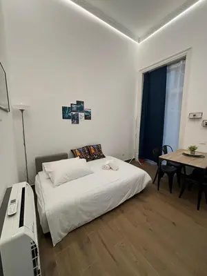 a black kitchen with a sink and a refrigerator at Gea Apartment in Palermo