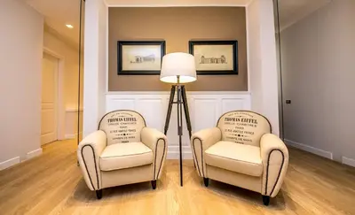 two chairs and a floor lamp in a room at Suite 136 in Palermo