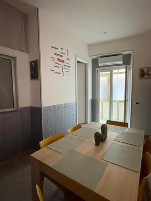a conference room with a table and chairs and a board at Le mura di San Vito in Palermo