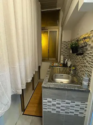 a small kitchen with a sink and a window at Le mura di San Vito in Palermo