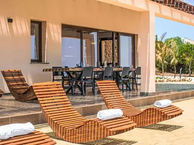a patio with chairs and a table and a pool at Villa Cleope by Interhome in Castellammare del Golfo