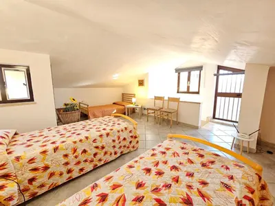 a bedroom with two beds and a table and chairs at Holiday Home Villa mit Wasserblick by Interhome in Cefalù