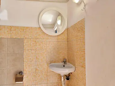 a bathroom with a sink and a mirror at Holiday Home Villa mit Wasserblick by Interhome in Cefalù