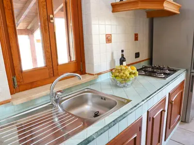 a kitchen with a sink and a bowl of fruit at Holiday Home Villa mit Wasserblick by Interhome in Cefalù