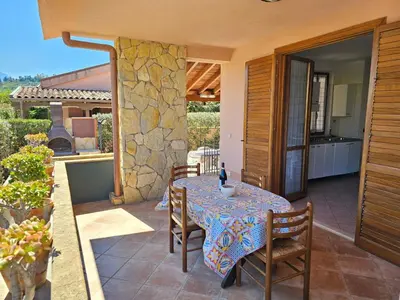 a table and chairs on the patio of a house at Holiday Home Helle mediterrane Villa mit Veranda und Garten by Interhome in Cefalù