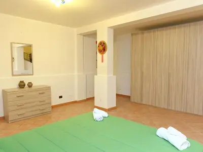 a bedroom with a bed and a dresser in a room at Holiday Home Helle mediterrane Villa mit Veranda und Garten by Interhome in Cefalù