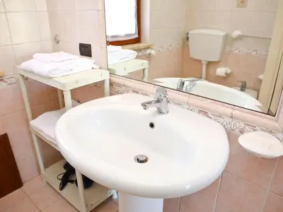 a bathroom with a white sink and a mirror at Holiday Home Helle mediterrane Villa mit Veranda und Garten by Interhome in Cefalù