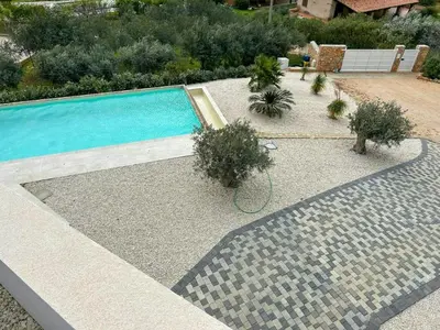a swimming pool with plants in a yard at Sustainable Villa With Infinity Pool in Castellammare del Golfo