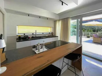 a kitchen with a sink and a large window at Sustainable Villa With Infinity Pool in Castellammare del Golfo