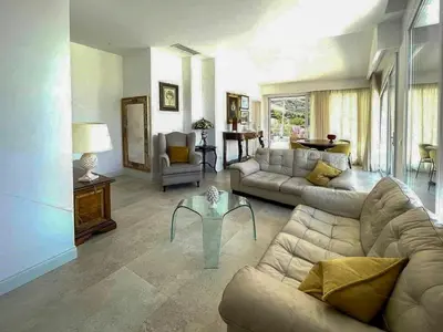 a living room with a couch and a table at Sustainable Villa With Infinity Pool in Castellammare del Golfo