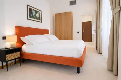 a bedroom with a bed and a wooden headboard at Dimora Monteleone in Palermo