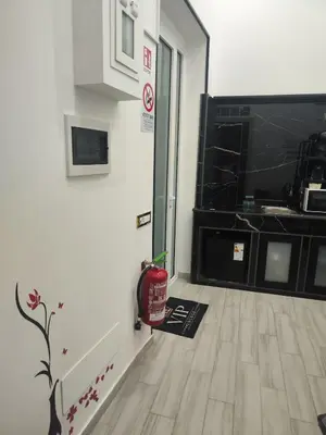a room with a fire extinguisher on the floor next to a door at Magic House in Palermo