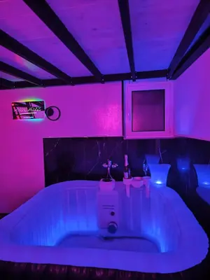 a room with a tub with purple lights in it at Magic House in Palermo