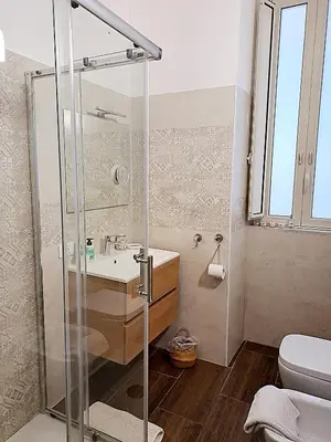 a bathroom with a shower and a sink and a toilet at Clara Bedda in Palermo