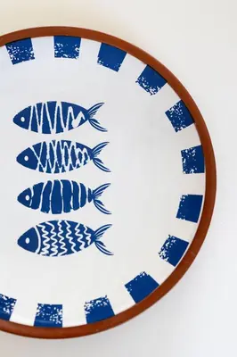a blue and white plate with fish on it at Vista Monte Cofano in Castelluzzo