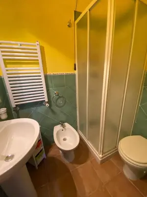 a bathroom with a shower and a toilet and a sink at Baglio Cuttaia in Carini