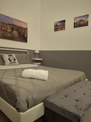 a large bed in a bedroom with two pictures on the wall at Compa House - Palermo Center in Palermo