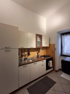 a kitchen with white cabinets and a sink at Compa House - Palermo Center in Palermo