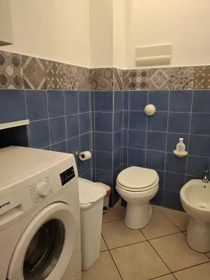 a bathroom with a washing machine and a toilet at Compa House - Palermo Center in Palermo